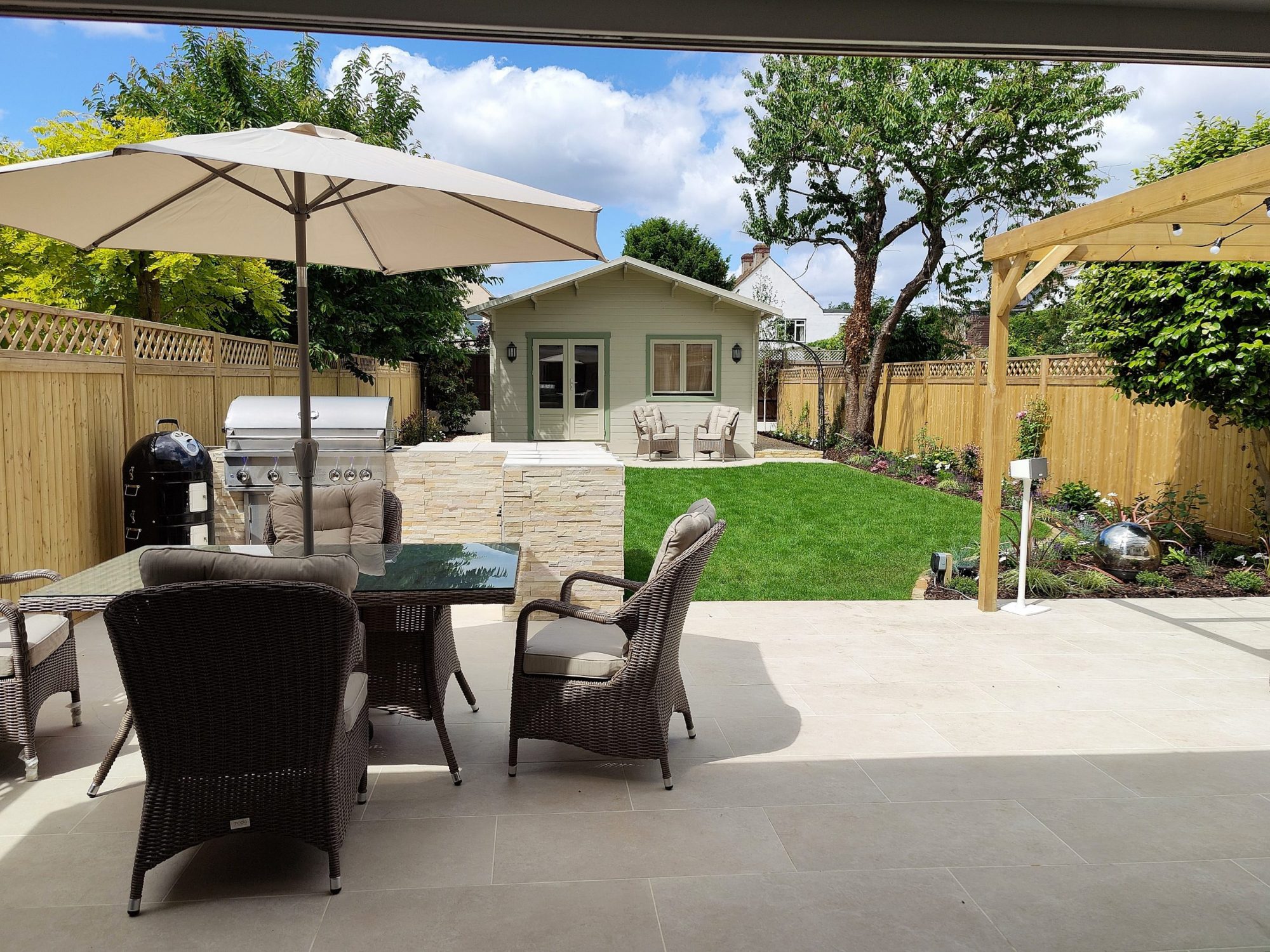 Family garden in bromley with outdoor kitchen, garden room and pergola