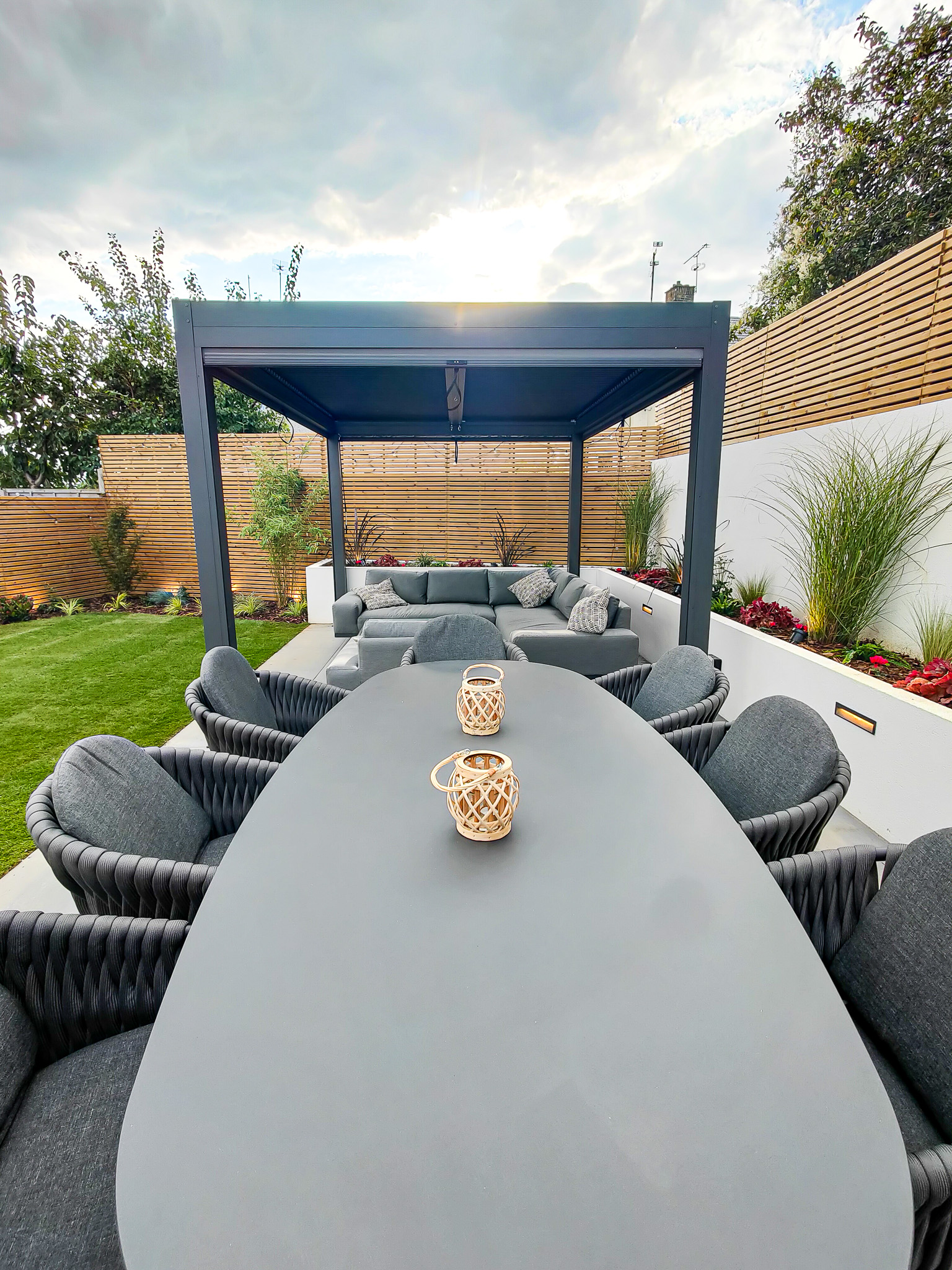 Bromley entertaining garden with pergola and sofa and dining set